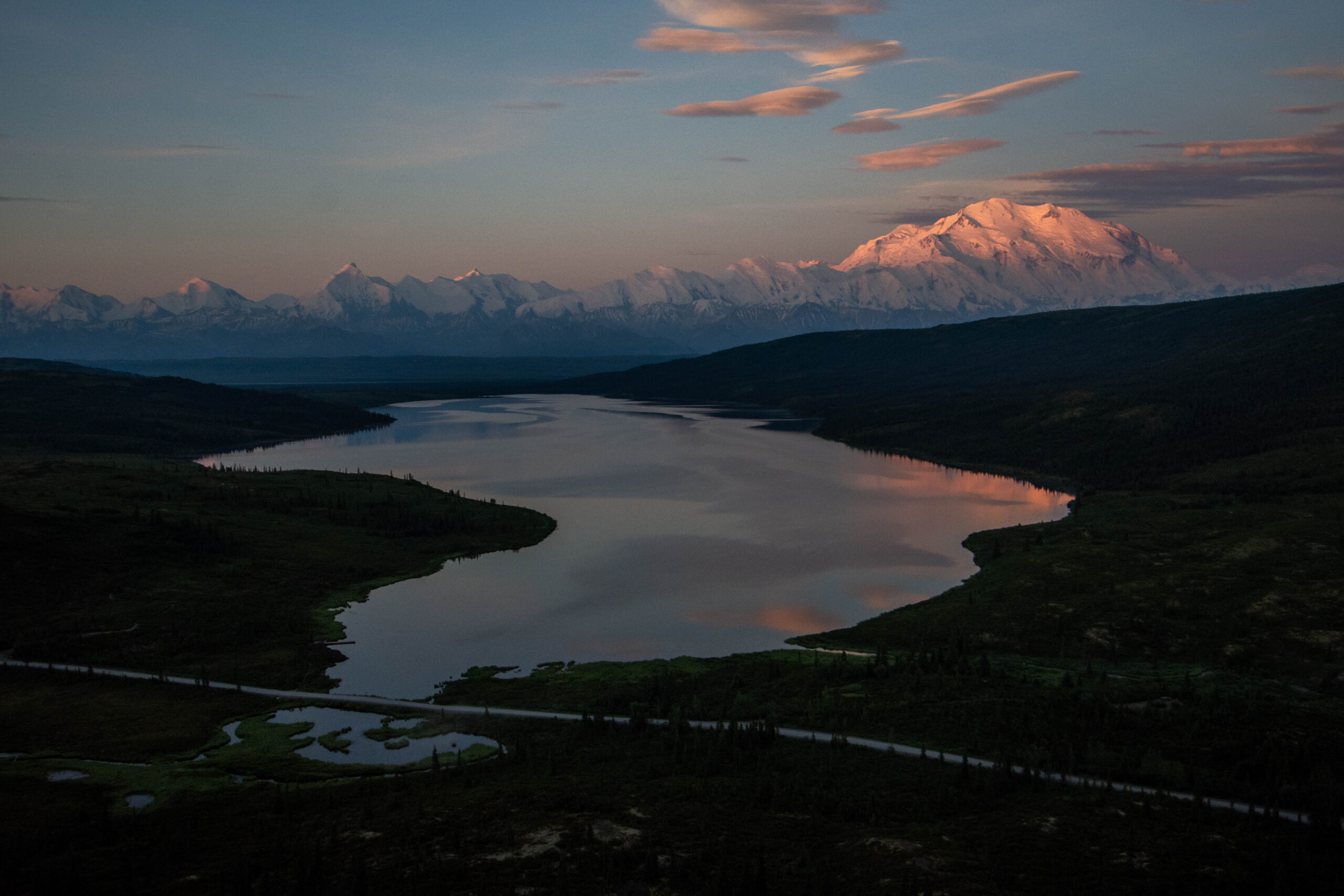 Sunrise tinges the top of Denali pink, seen from Wonder Lake